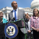 U.S. Sen Cory Booker (D-NJ) (C), joined by Sen. Elizabeth Warren (D-MA) (L) and Rep. Carolyn Maloney (D-NY), speaks at a press conference on bank overdraft fees on July 12, 2022, in Washington, DC